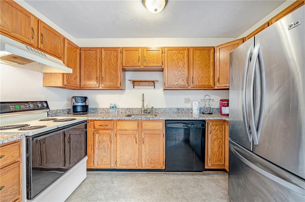 820 Mt Pleasant Road Greensburg, PA 15601 - Photo 10 of 30 a kitchen with stainless steel appliances granite countertop a refrigerator sink and cabinets