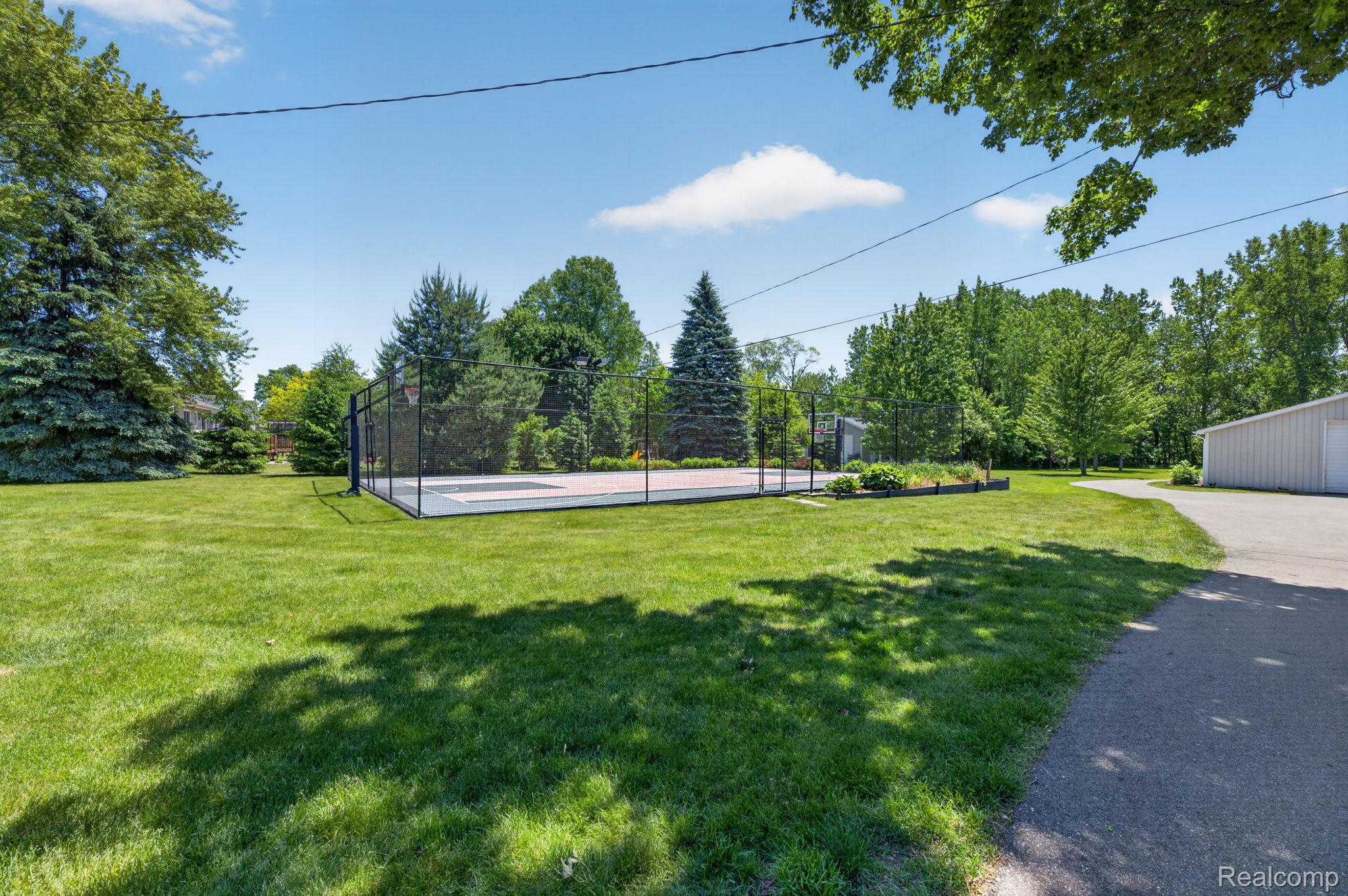 9353 Hill Road Swartz Creek, MI 48473 - Photo 11 of 98 Private outdoor court area with black chain-link fencing