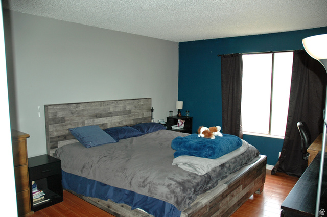46 Lester Avenue, Unit G 24 Murray, UT 84107 - Photo 12 of 16 Spacious primary bedroom a large window with privacy coverings and half bath.