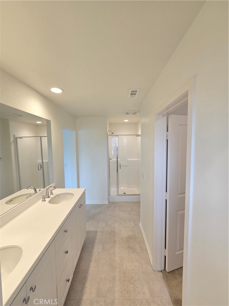 879 Iris Way, Unit A Azusa, CA 91702 - Photo 13 of 21 a spacious bathroom with a double vanity sink and a mirror