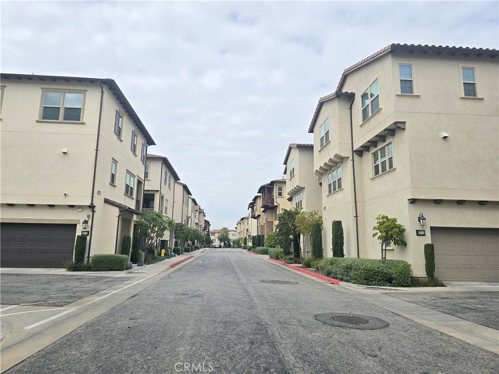 879 Iris Way, Unit A Azusa, CA 91702 - Photo 15 of 21 a view of a white building among the street with palm trees