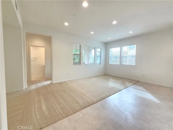 an empty room with windows and entrance
