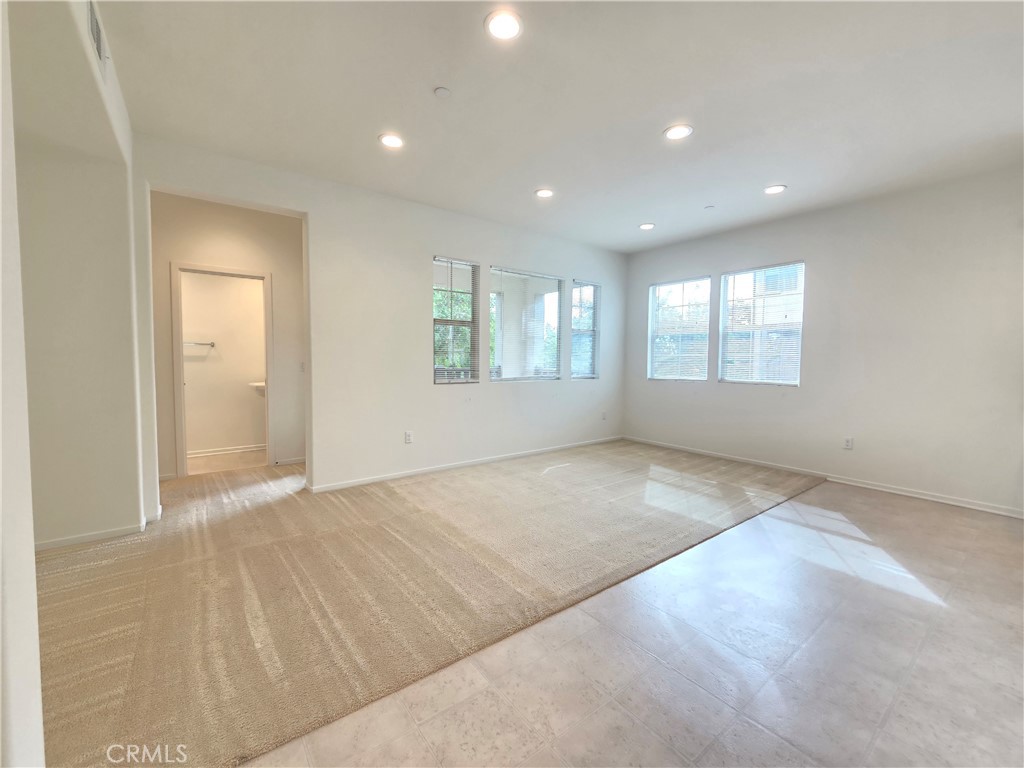 879 Iris Way, Unit A Azusa, CA 91702 - Photo 2 of 21 an empty room with windows and entrance