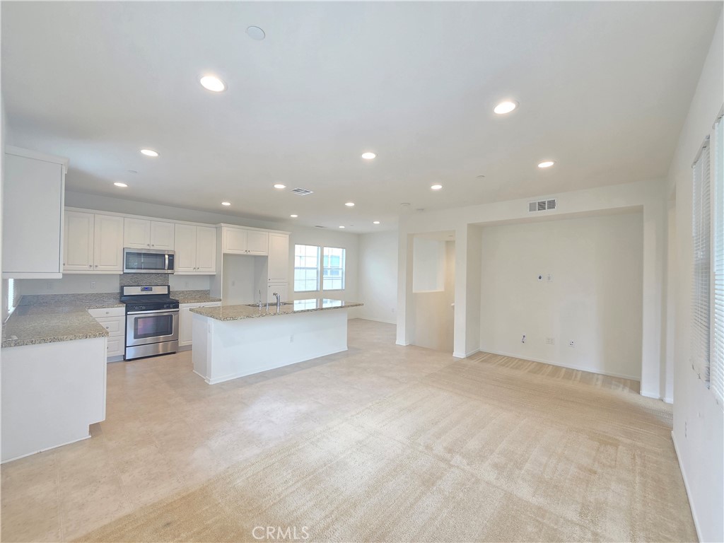 879 Iris Way, Unit A Azusa, CA 91702 - Photo 4 of 21 a view of kitchen with kitchen island and stainless steel appliances