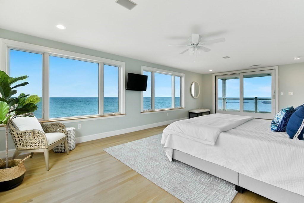 16 Burr Road Hull, MA 02045 - Photo 13 of 25 a spacious bedroom with a bed and a chair