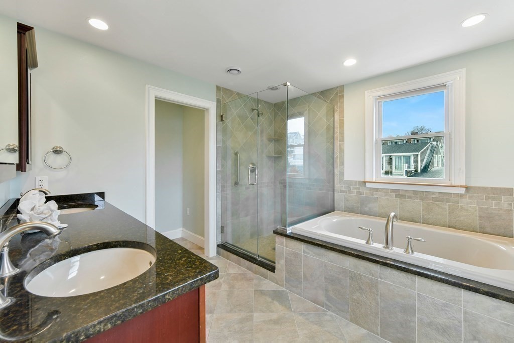 16 Burr Road Hull, MA 02045 - Photo 14 of 25 a spacious bathroom with a granite countertop tub sink and mirror
