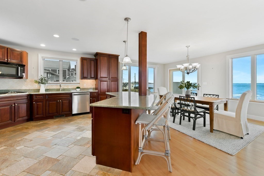 16 Burr Road Hull, MA 02045 - Photo 6 of 25 a kitchen with a table chairs sink and cabinets