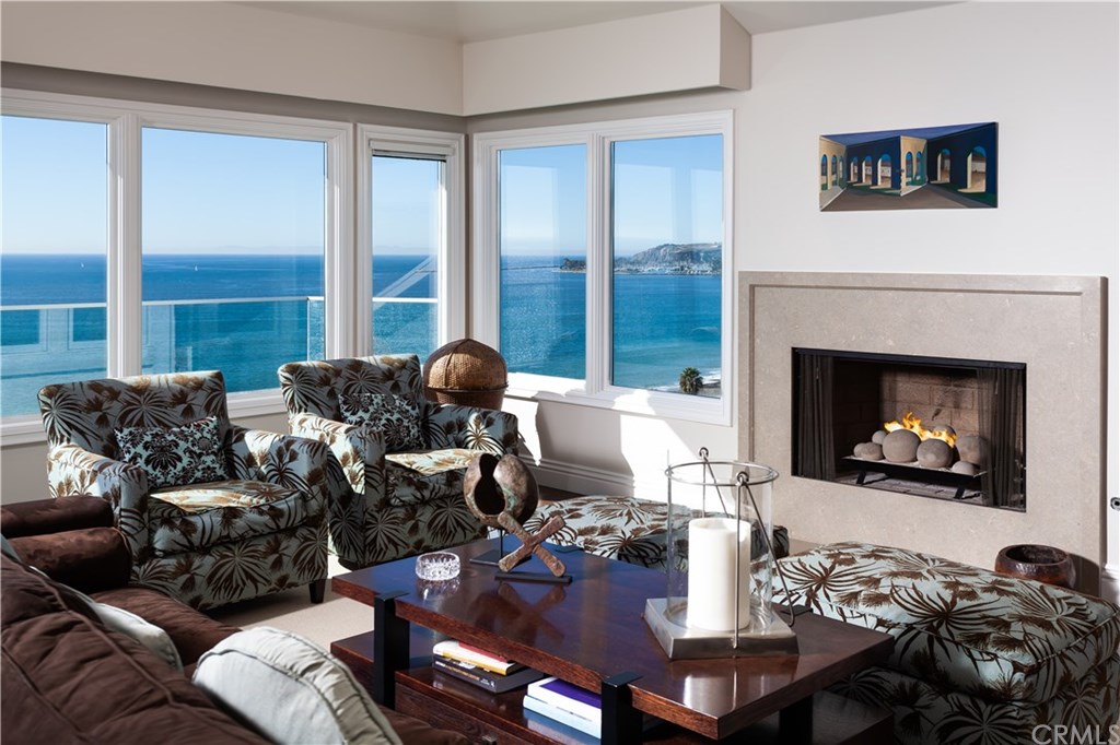 34861 Doheny Place Dana Point, CA 92624 - Photo 19 of 32 Upstairs living room with gas fireplace and great views of Dana Point Harbor.