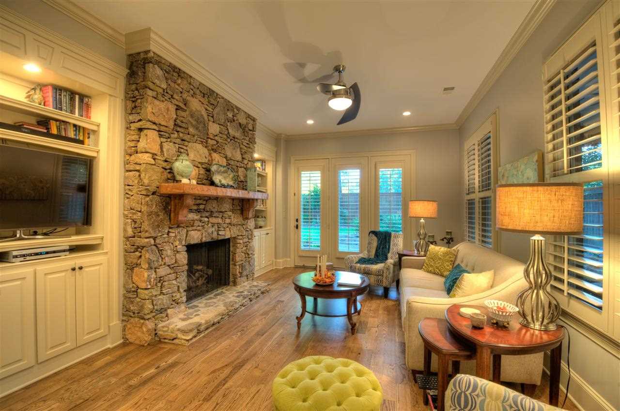 1277 South Dubray Place Collierville, TN 38017 - Photo 8 of 25 Stone fireplace and custom built floor to ceiling bookcases, hardwood floors, ten foot smooth ceilings will help you relax and enjoy your quiet time in the 19x13 Hearth Room