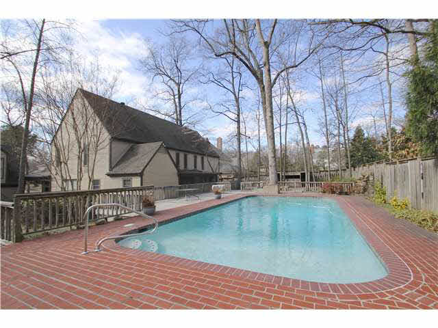 2288 Kirby Road Memphis, TN 38119 - Photo 2 of 25 Relax outside in this amazing backyard with a sparkling in-ground pool, tiki bar, and deck. Imagine all the fun parties you can have with a set up like this!