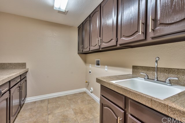 3086 Diamondview Circle Corona, CA 92882 - Photo 39 of 66 The downstairs laundry room has a laundry chute, lots of cabinets and counter space, and an utility sink.