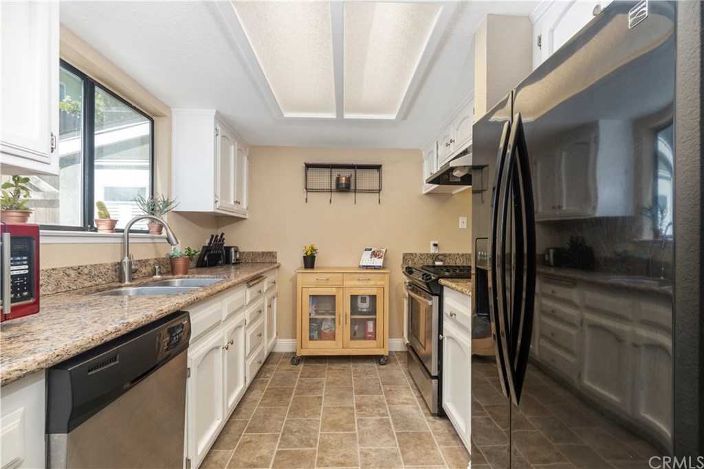 628 4th Street Paso Robles, CA 93446 - Photo 8 of 22 Galley style kitchen that is open to the living room and overlooks the rear patio.