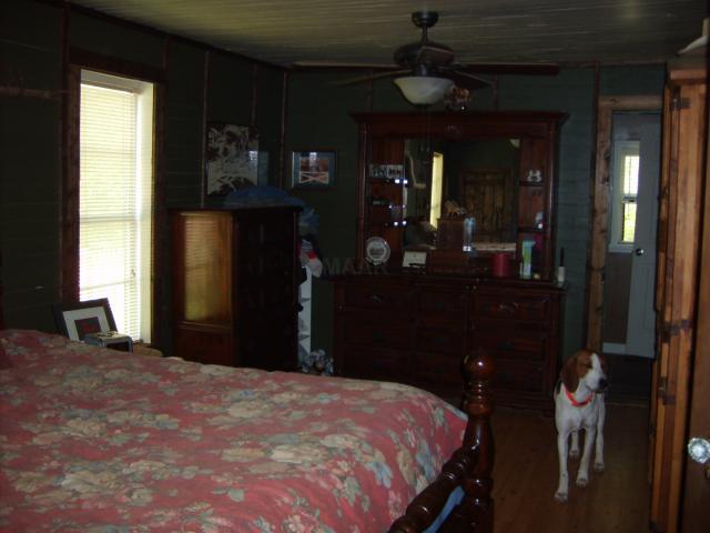 972 Hawkins Road Burlison, TN 38015 - Photo 5 of 12 This large master bedroom has lots of wood trims and great wood floors.