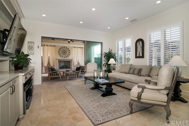 17 Rawhide Irvine, CA 92602 - Photo 9 of 56 Large sliding glass doors and extensive indoor and outdoor travertine allow for seamless indoor/outdoor living. Indoor living room features grand built in media center.