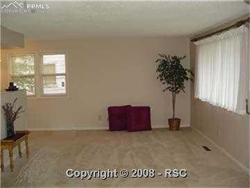 2513 Alexander Road Colorado Springs, CO 80909 - Photo 4 of 16 Bright, open living room.