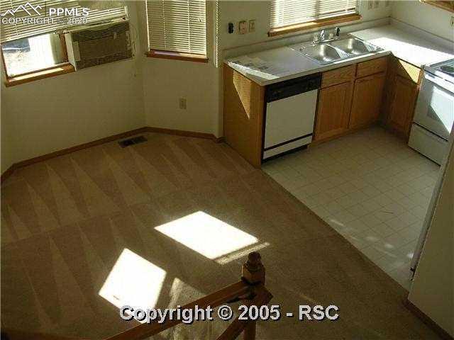 621 Rye Ridge Road Fountain, CO 80817 - Photo 2 of 8 Kitchen & Dining area as seen from upstairs.