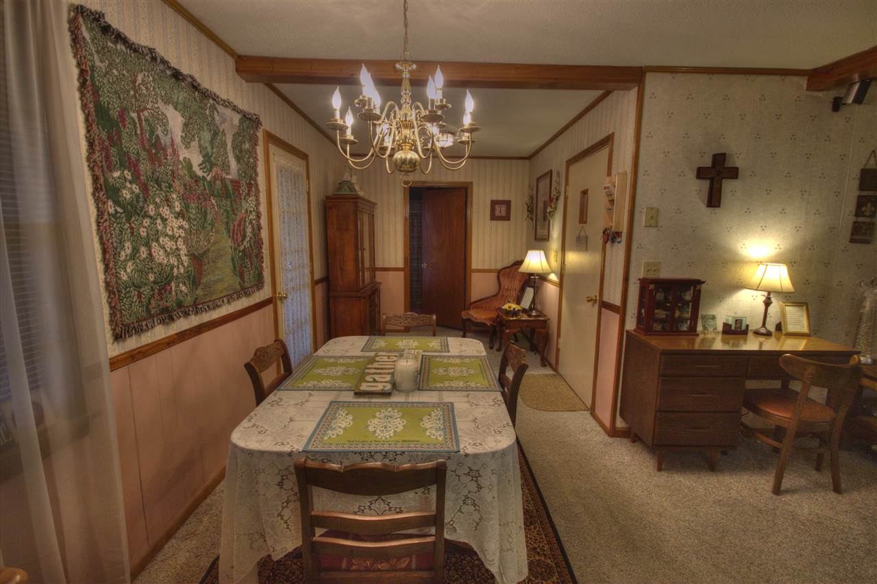 4924 Holly Grove Road Brighton, TN 38011 - Photo 25 of 25 The dining area is just off of the kitchen, and is also open into the great room. This continues the open concept floorplan, and is great for entertaining. The screened-porch is just outside the door to the left.