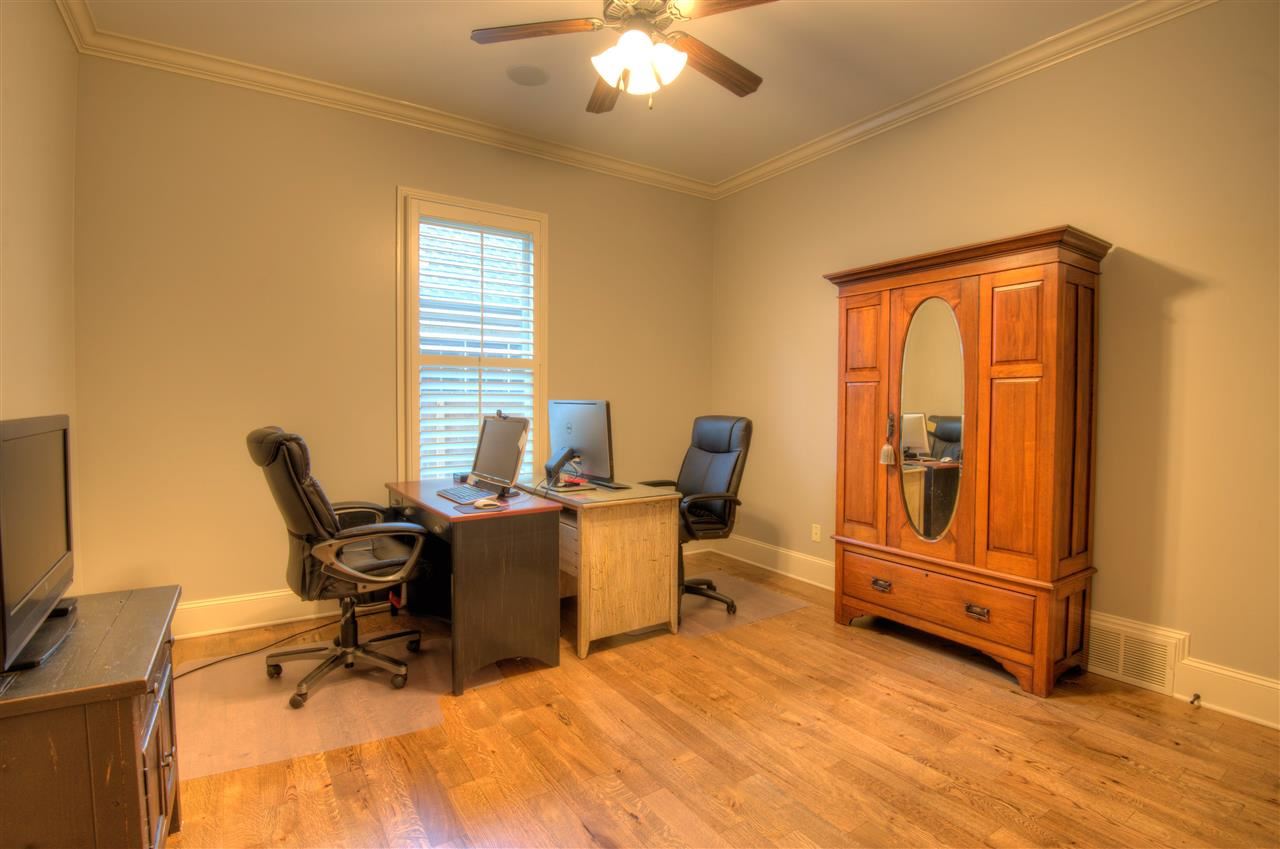 1277 South Dubray Place Collierville, TN 38017 - Photo 13 of 25 15x13 second bedroom on the main level with private bath. Gorgeous hardwood floors, ten foot smooth ceiling and plantation shutters.