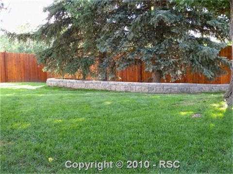 649 Paradise Lane Colorado Springs, CO 80904 - Photo 10 of 13 Large flat lot with covered patio, trees, sprinkler system