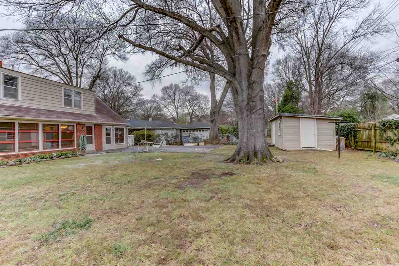 1096 West Perkins Road Memphis, TN 38117 - Photo 24 of 25 Relax outside in the fenced backyard with a nice storage shed and a delightful patio, perfect for cookouts and parties! Do not miss out on this amazing East Memphis home!