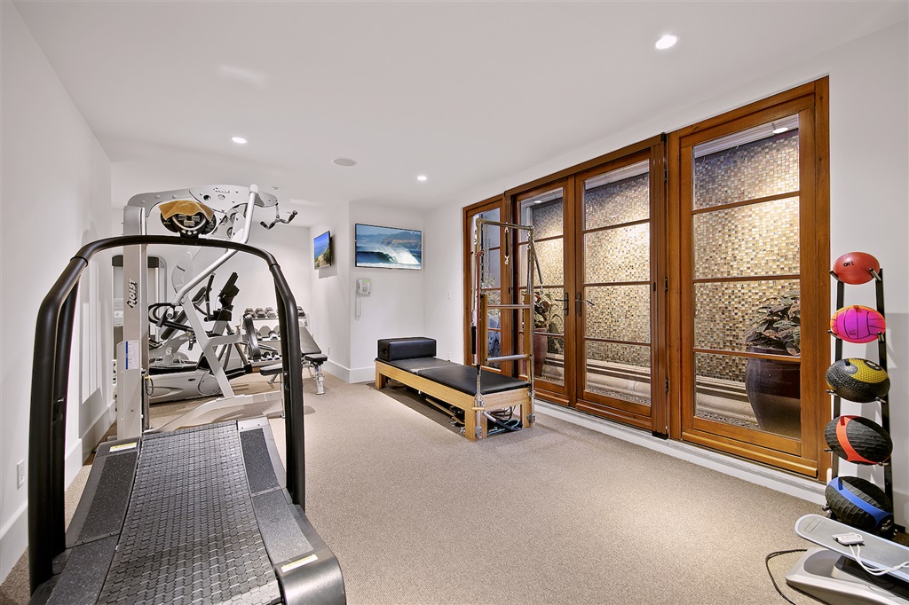 6221 Mimulus Rancho Santa Fe, CA 92067 - Photo 15 of 25 Great work out room with waterfall wall as a soothing background. Private steam shower in gym bathroom.