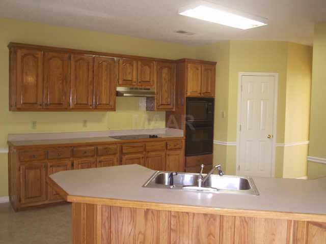 760 Shelton Road Collierville, TN 38017 - Photo 4 of 10 The Kitchen is phenomenally spacious with two pantries, smooth cooktop, ample cabinet & counter space, and breakfast bar opening to eat-in area.