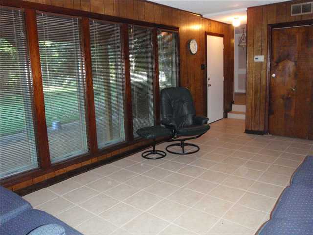 2923 Invergarry Road Memphis, TN 38128 - Photo 6 of 12 Large den features tile floor and wall of windows looking out on pergola covered patio.