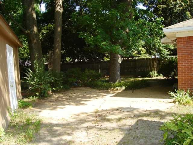 1561 Colonial Road Memphis, TN 38117 - Photo 14 of 15 Fenced Rear Yard with Mature Trees and Patio - PLUS There is also a Storage Building!