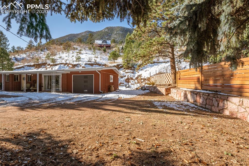 8715 Chipita Park Road Cascade, CO 80809 - Photo 6 of 33 Single car attached garage with lots of additional flat space for parking or storage