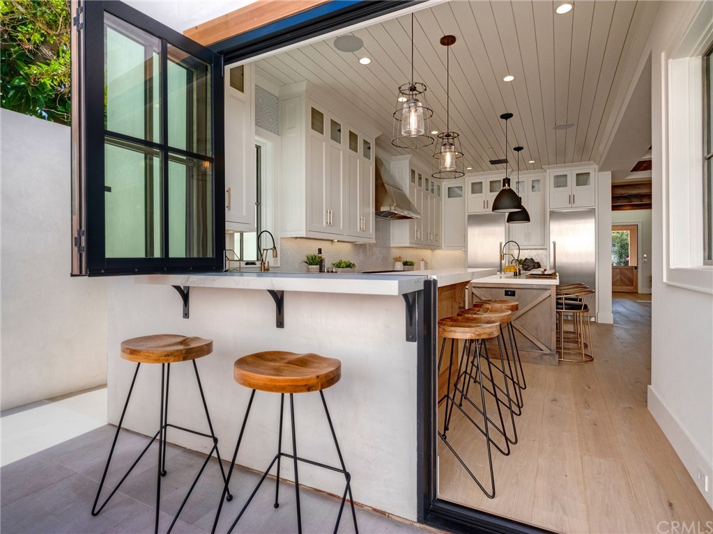 559 31st Street Manhattan Beach, CA 90266 - Photo 10 of 49 Indoor/outdoor bar & entertainment area that opens to backyard. Neolith stone counters, Thermador professional series appliances, dual sinks, additional beverage fridge, Brizo faucets, breakfast counter.