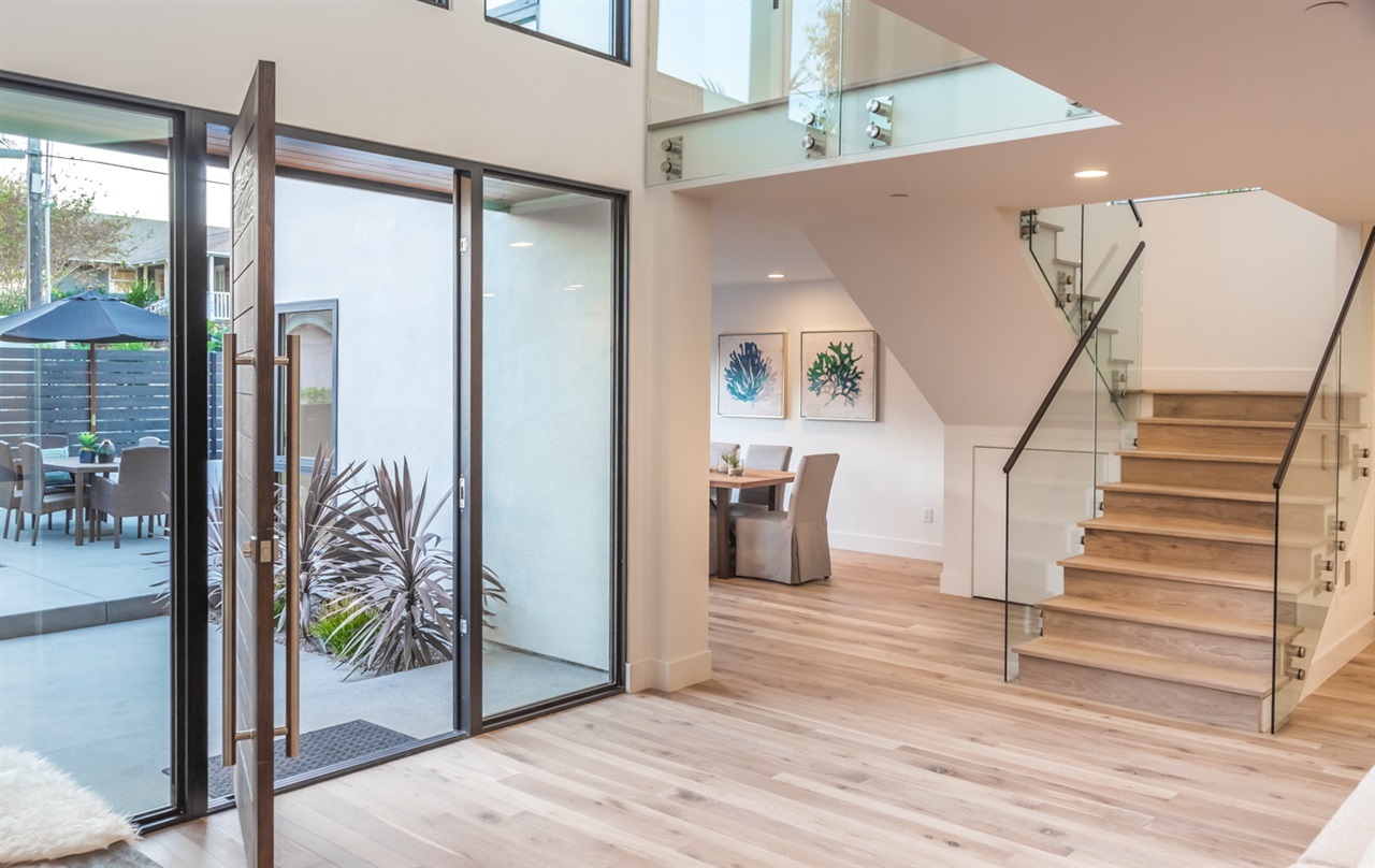 244 Pacific Avenue Solana Beach, CA 92075 - Photo 4 of 20 Custom glass railing system with volume ceiling and a custom Western front entry pivot door