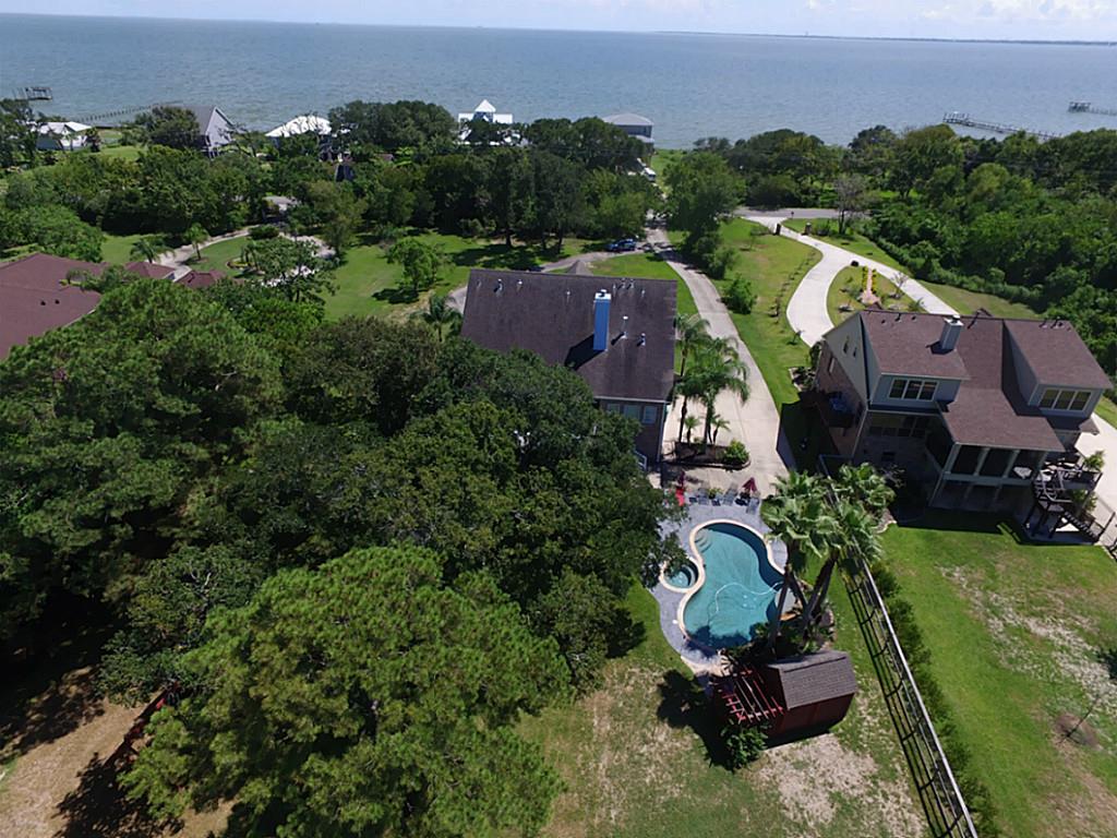 Situated on 1.47 acres - Come home to breathtaking views of Galveston Bay in front & a nature preserve in back, w/ 100+ yr old Live Oak trees!