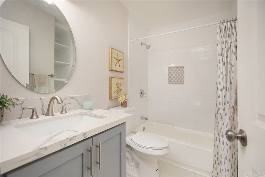 1745 North Bates Circle Anaheim, CA 92806 - Photo 22 of 32 Guest bathroom with quartz counters, shaker vanity, and subway tile bath