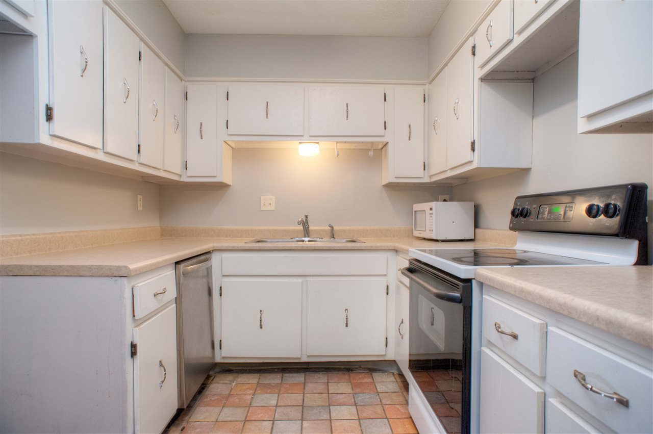 8493 Rothchild Road, Unit 59 Germantown, TN 38139 - Photo 9 of 17 Kitchen with 22 Cabinets, Tile Floor, Range/Oven, Dishwasher, & Disposal