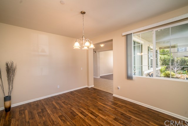 5473 Stoneview Road Rancho Cucamonga, CA 91739 - Photo 7 of 56 Formal dining room with new laminate flooring