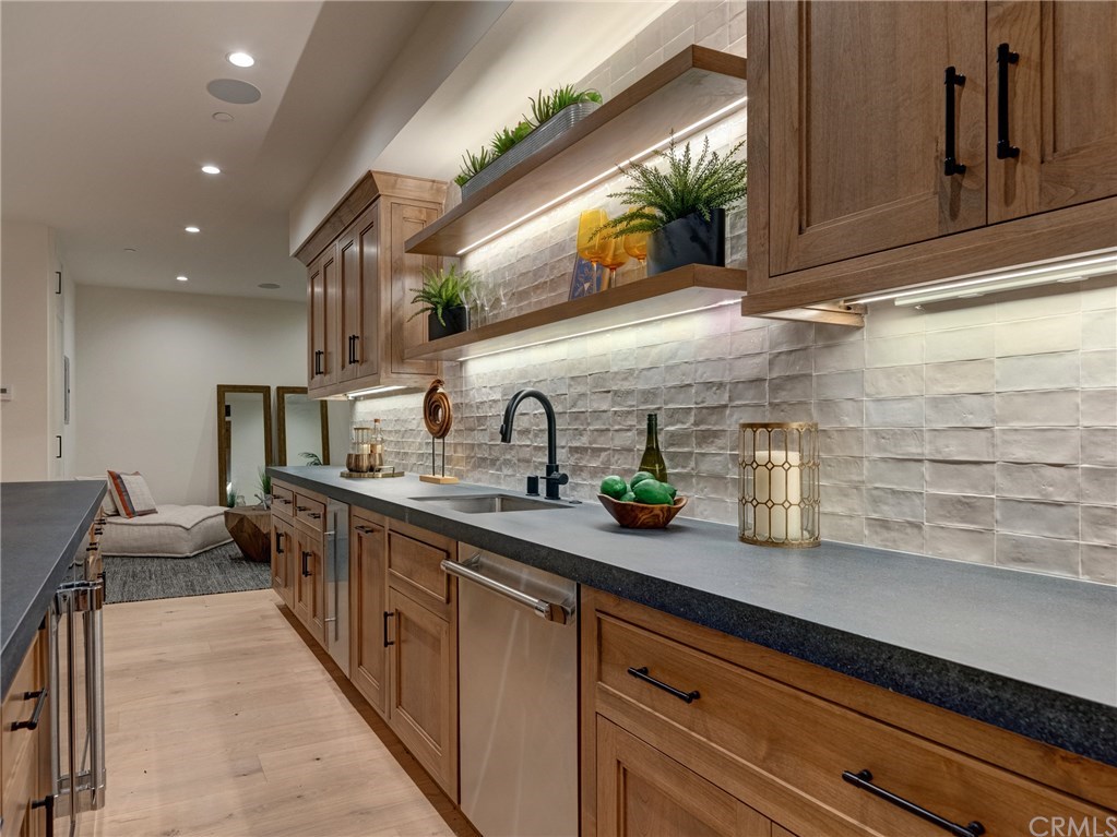 559 31st Street Manhattan Beach, CA 90266 - Photo 23 of 49 HUGE 1,557 sq. ft. entertainer's dream basement with full bar, dishwasher, ice maker, fridge, 86" TV already installed, surround sound, wired for Dolby Atmos 9.4.2 channel cinema, lounge area, half bath, downstairs bedroom suite.