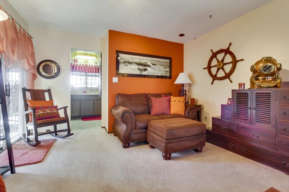 1399 Panorama Ridge Road Oceanside, CA 92056 - Photo 9 of 25 A warm, inviting & spacious living room with overhead fans, decorated in warm hues of persimmon color.