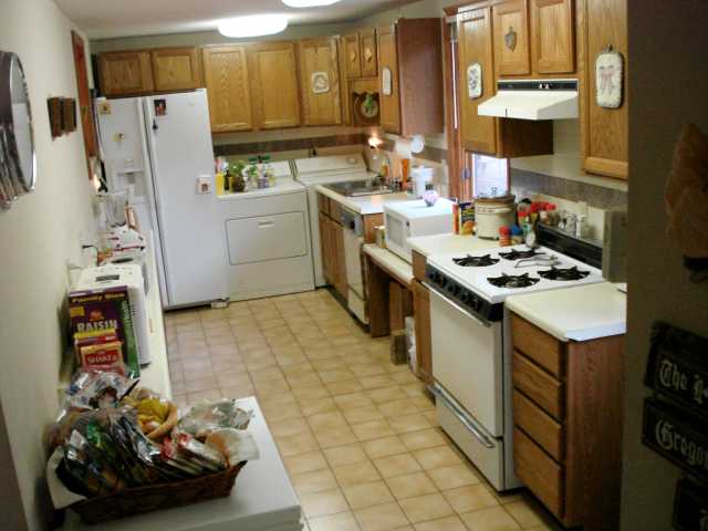 Galley style kitchen was added to house in 1995 with other renovations and additions.  Washer and dryer stay in kithchen.  Mexican tile floor.