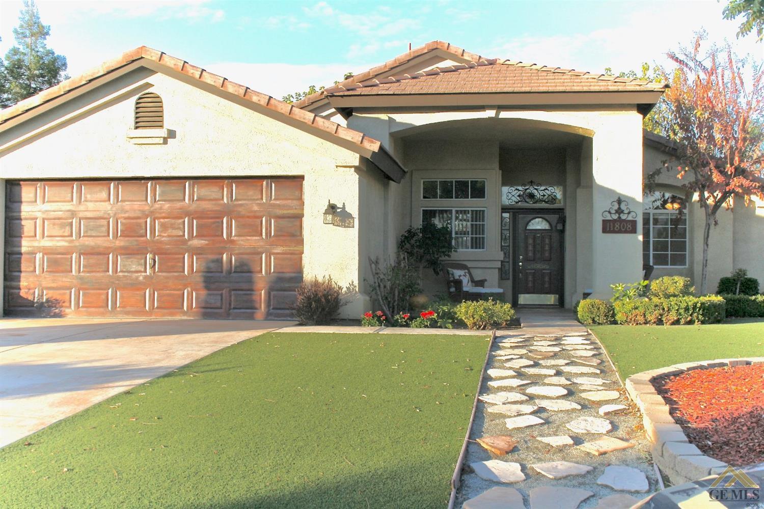 Faux painted garage door, stunning custom-painted front door and artificial turf gives this house the best curb appeal in the Villages of Brimhall!