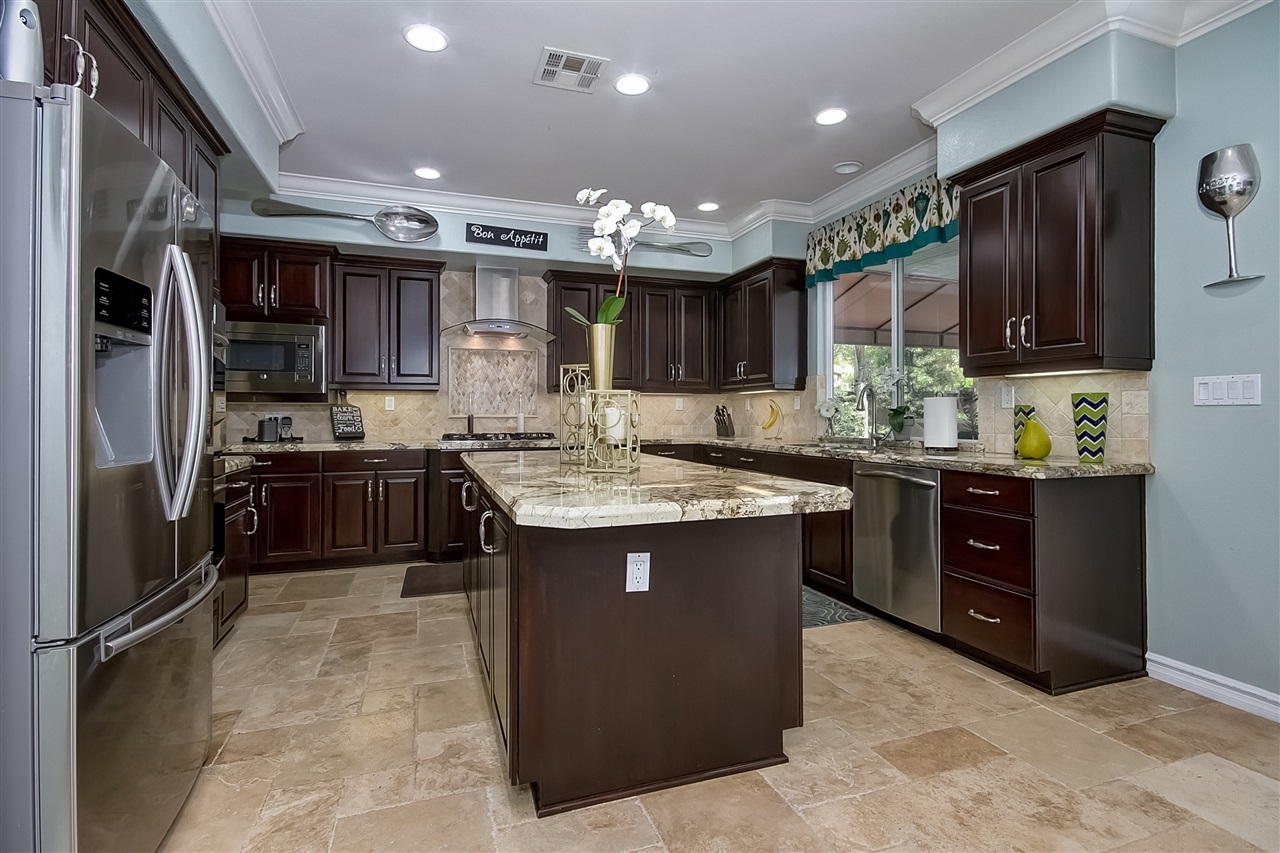 1853 Shadetree Drive San Marcos, CA 92078 - Photo 7 of 25 Huge Gourmet Kitchen with Newer High End Granite and New cabinet door faces/hardware and cabinets have been re-stained, vast amount of storage.
