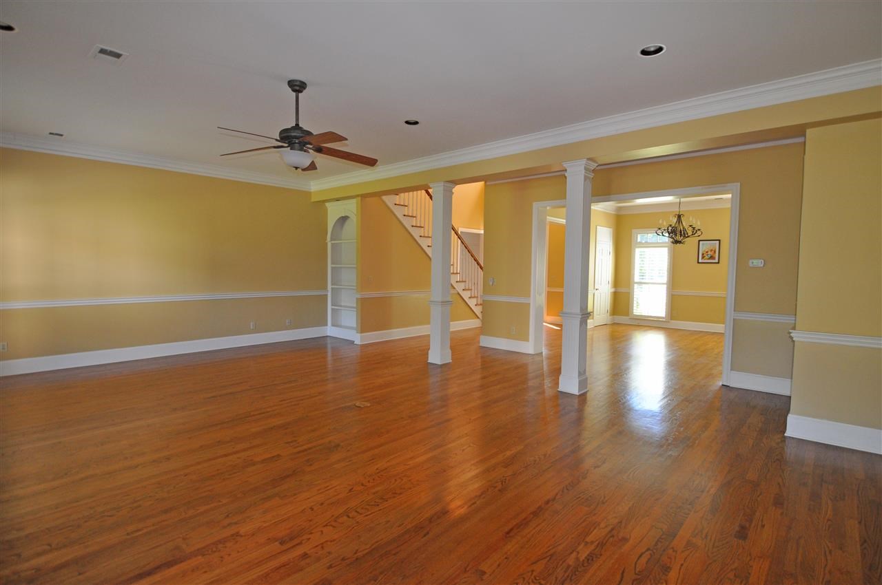 9450 Johnson Road Germantown, TN 38139 - Photo 6 of 25 The family-sized great room features built-in bookcases, crown molding, recessed lighting, and hardwood floor.