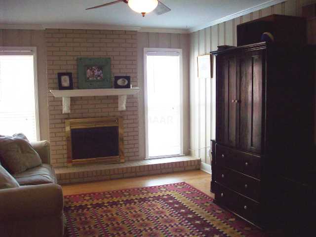 1576 Hayne Road Memphis, TN 38119 - Photo 2 of 9 Family room with masonry fireplace, hardwood floors and smooth ceilings.