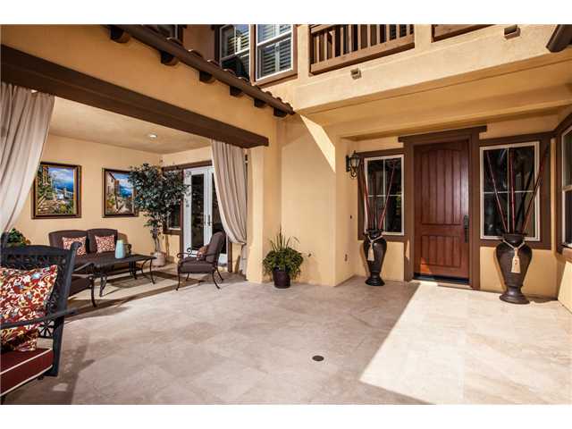 6989 Corte Langosta Carlsbad, CA 92009 - Photo 5 of 25 Private entertaining courtyard allows no one to access your front door unless invited. Stunning travertine floors laid with no grout line and raised hearth fireplace. French doors to the left enter the courtyard from the formal dining room.