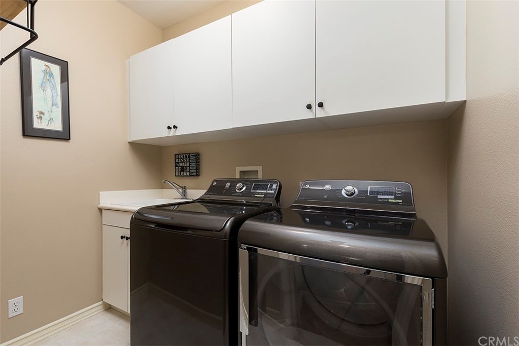 20 Winfield Drive Ladera Ranch, CA 92694 - Photo 35 of 47 Upstairs laundry room with sink and overhead cabinets ~