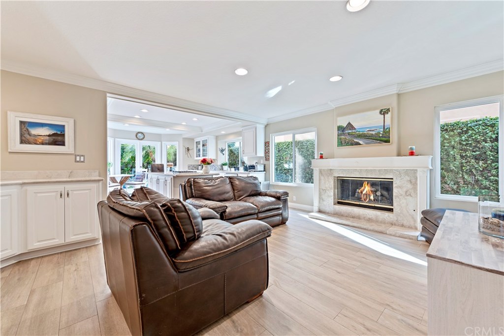 2152 Vallejo Drive Tustin, CA 92782 - Photo 14 of 35 Spacious Family Room with custom cabinets with stone counters, custom fireplace and beautiful wood floors.