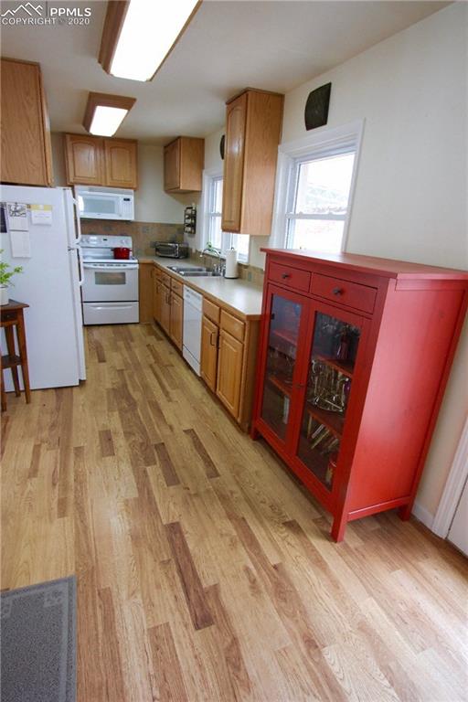 210 Crystal Park Road Manitou Springs, CO 80829 - Photo 5 of 34 Galley-Style Kitchen w/Hickory Floors