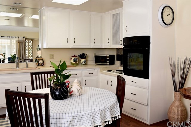 13881 Thunderbird Drive, Unit 64K Seal Beach, CA 90740 - Photo 12 of 21 Partial kitchen view showing numerous cabinets and drawers for ample storage.