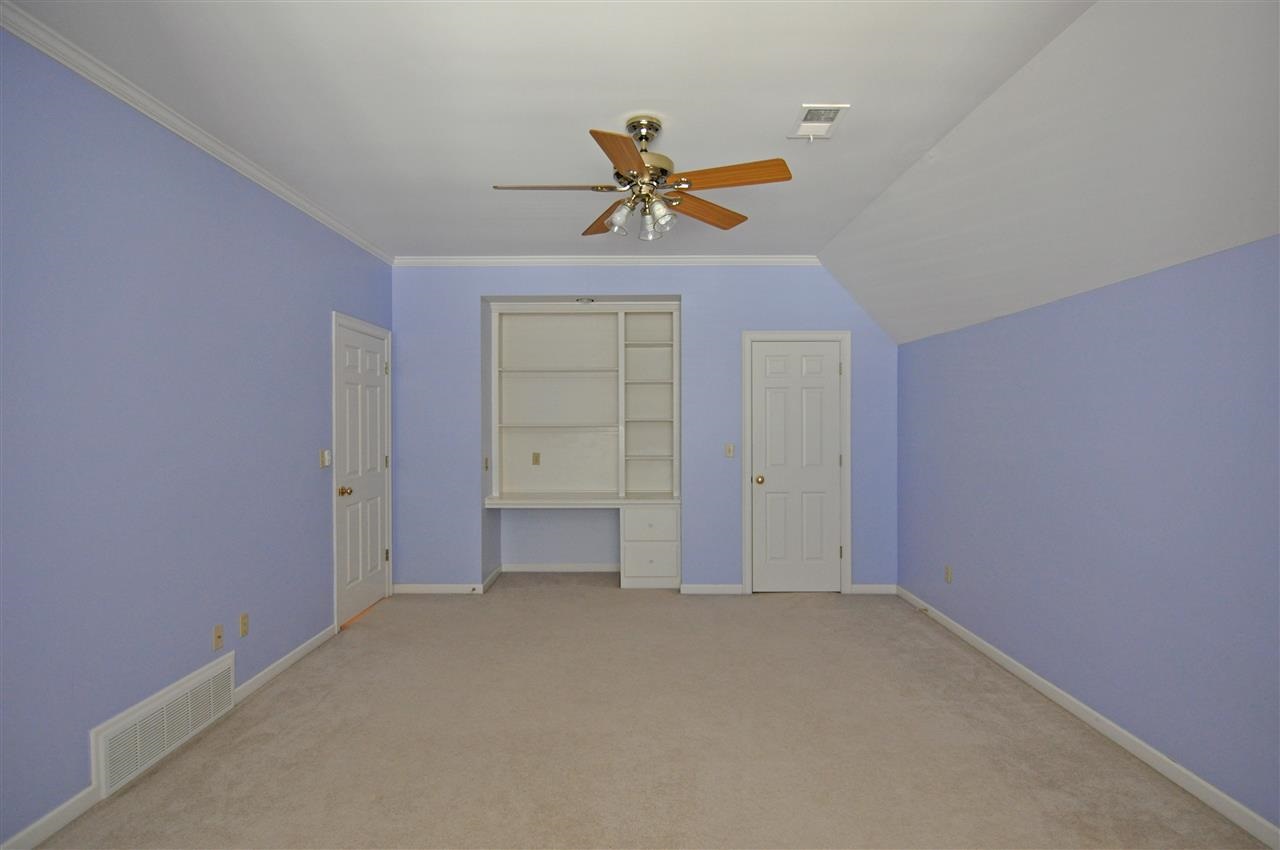 9450 Johnson Road Germantown, TN 38139 - Photo 22 of 25 The 3rd bedroom also features carpet, a built-in desk area, window seat with storage, ceiling fan, and large closet.