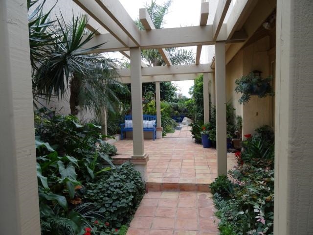 13312 Pantera Road San Diego, CA 92130 - Photo 19 of 25 Side yard entry with pergola and lush landscaping.