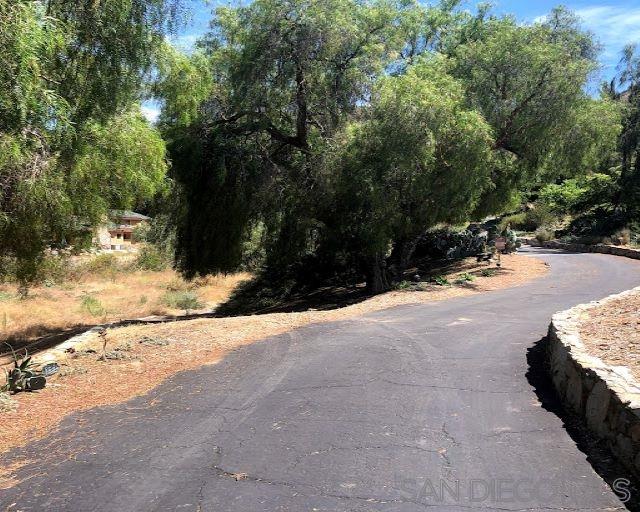Jamul Drive Jamul, CA 91935 - Photo 4 of 12 go left of this tree onto easement. Keep going mostly straight until you come to a point at a bush on the left as shown in another "entry photo. stay left of that bush and continue to the end. You will be able to turn around and come back. graveled.